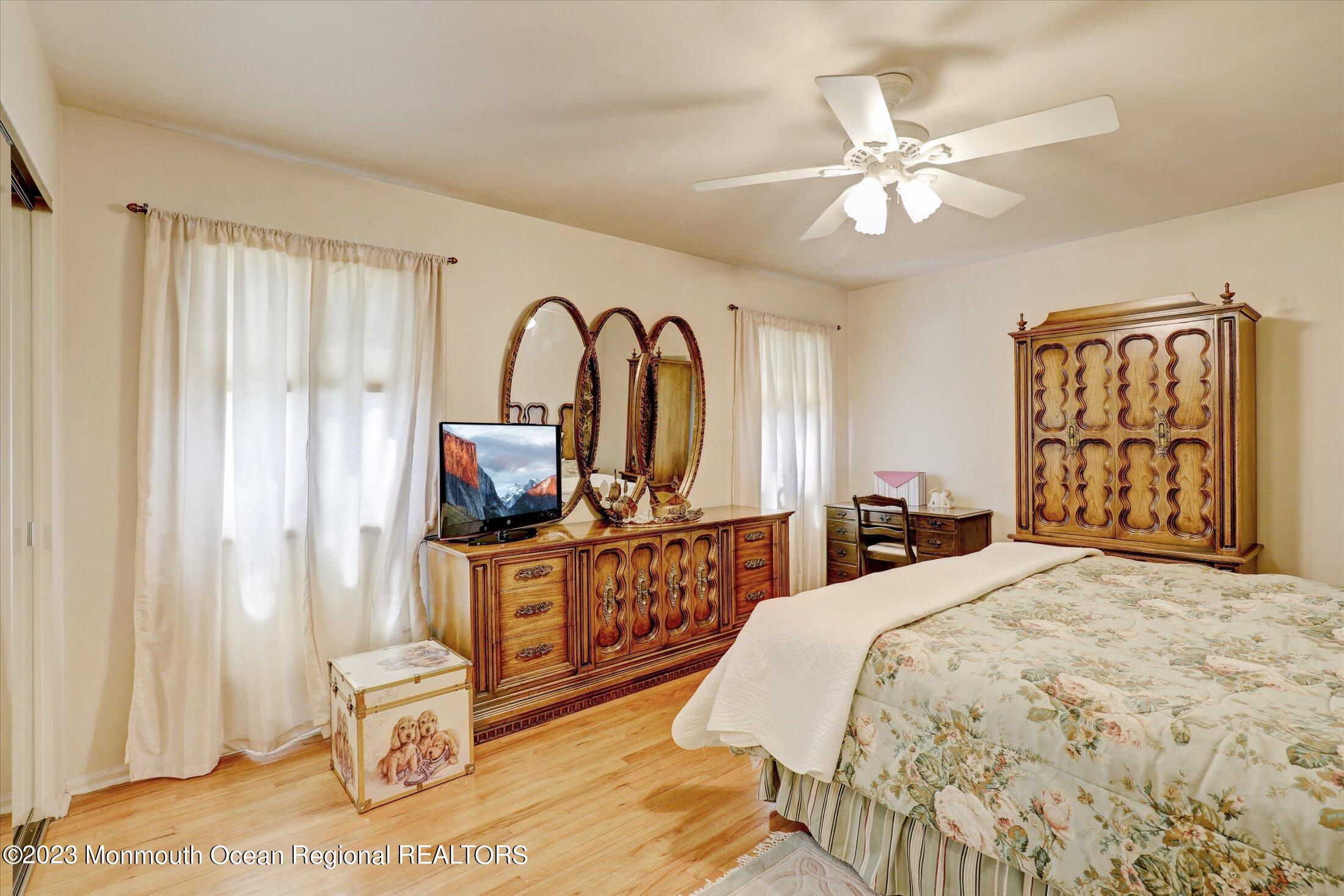 5 Ramble Way Hazlet, NJ 07730 - Photo 18 of 34 a bedroom with a bed and a chandelier