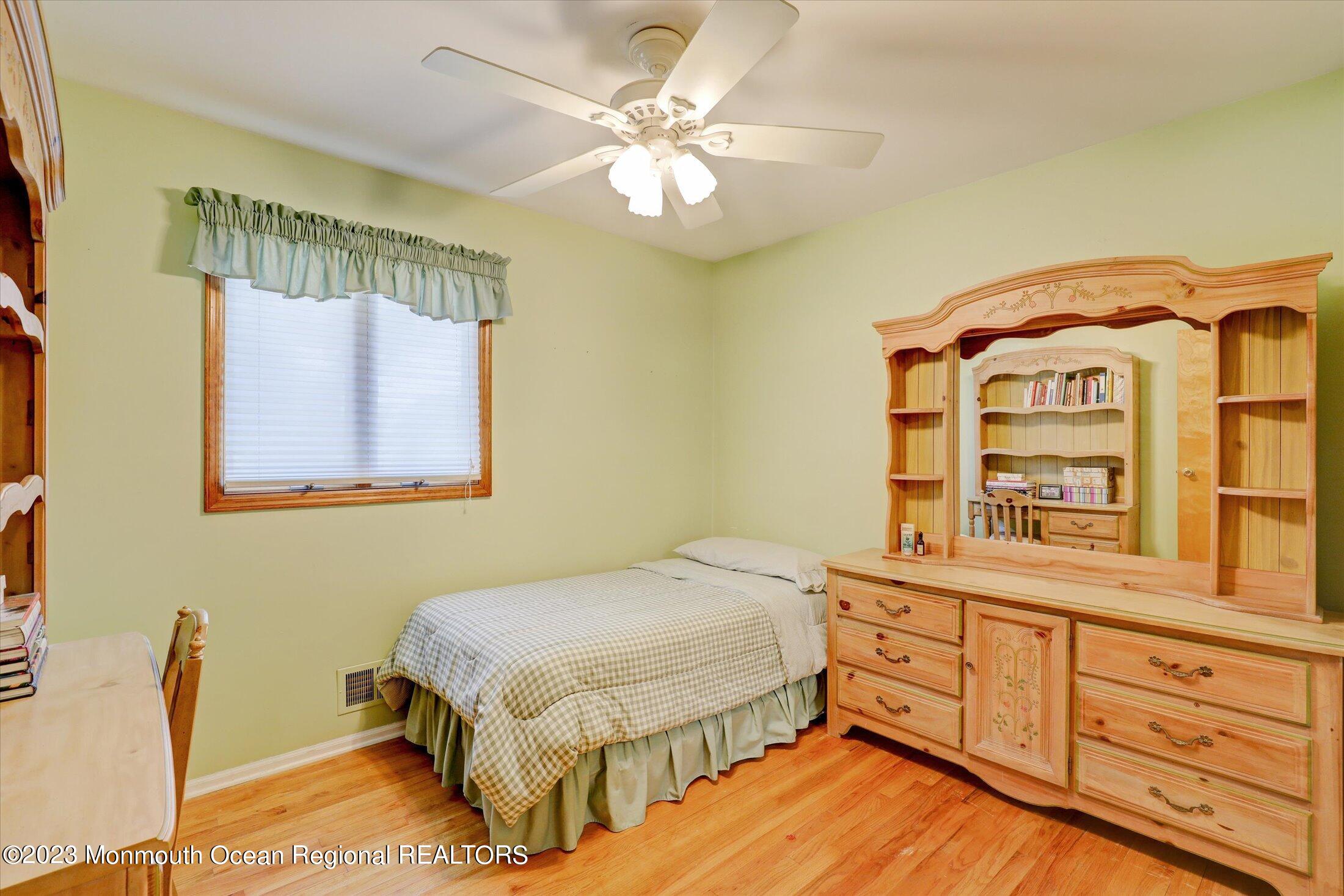 5 Ramble Way Hazlet, NJ 07730 - Photo 20 of 34 a bedroom with a bed and a chandelier