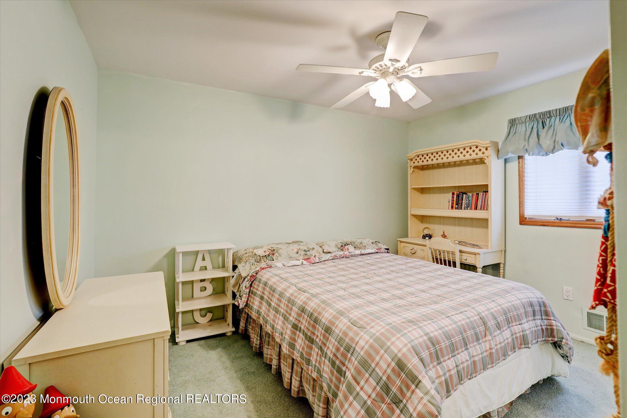 5 Ramble Way Hazlet, NJ 07730 - Photo 21 of 34 a bedroom with a bed and a chandelier
