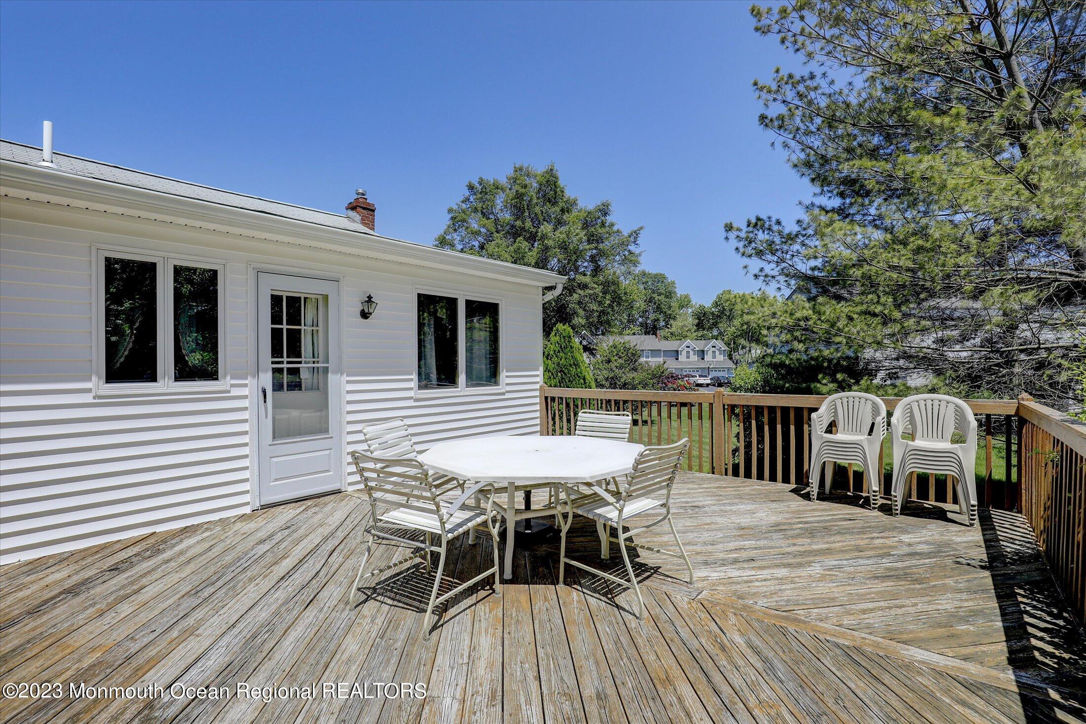 5 Ramble Way Hazlet, NJ 07730 - Photo 24 of 34 a balcony with wooden floor table and chairs