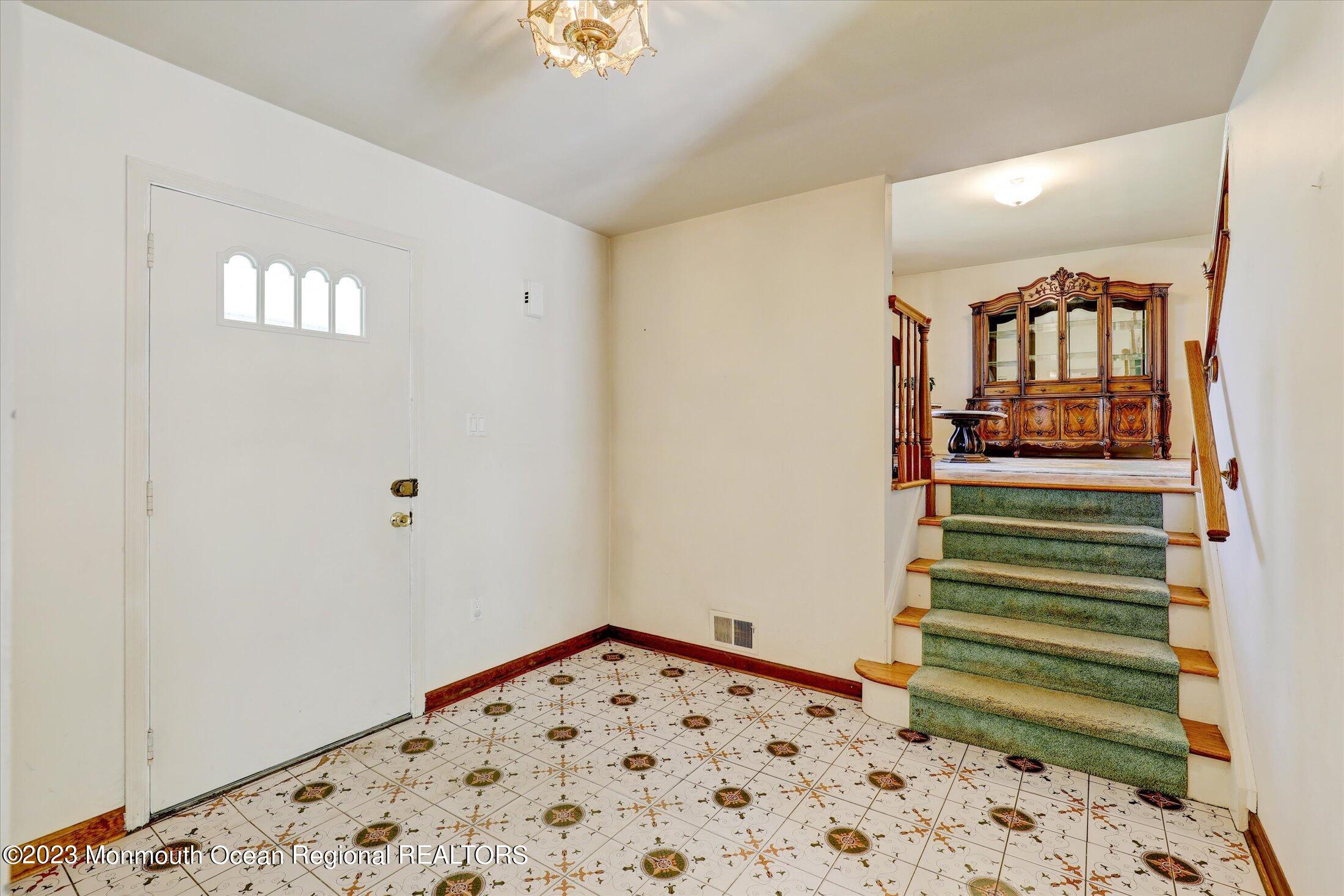 5 Ramble Way Hazlet, NJ 07730 - Photo 3 of 34 a view of a hallway with a window and stairs