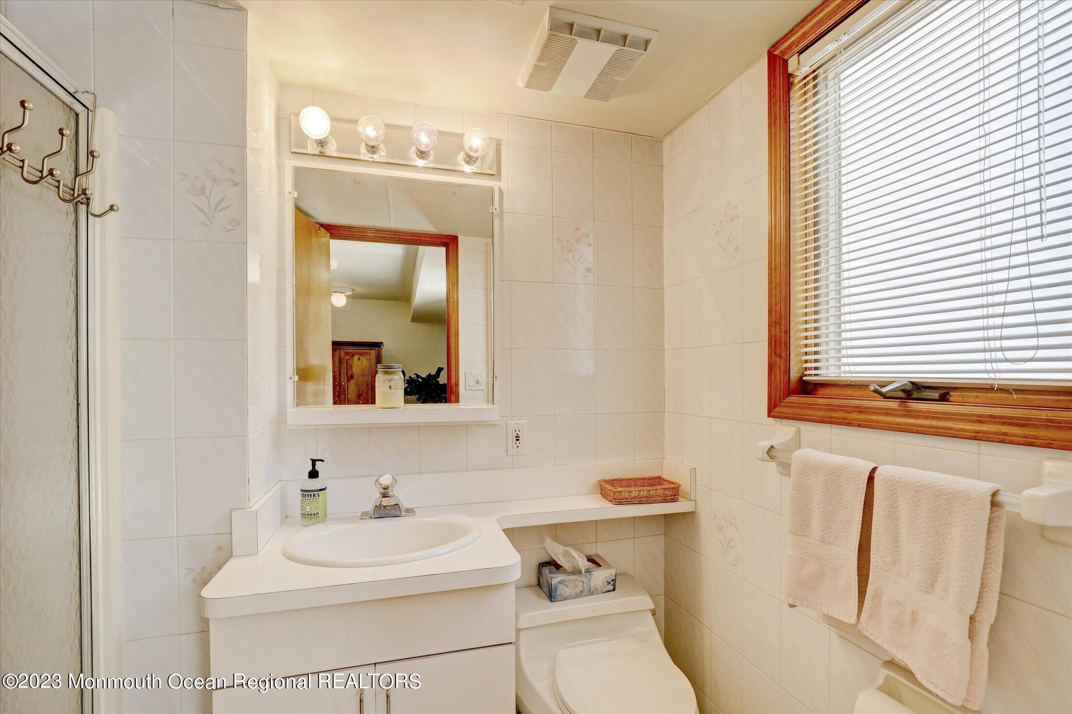 5 Ramble Way Hazlet, NJ 07730 - Photo 8 of 34 a bathroom with a sink vanity mirror and toilet