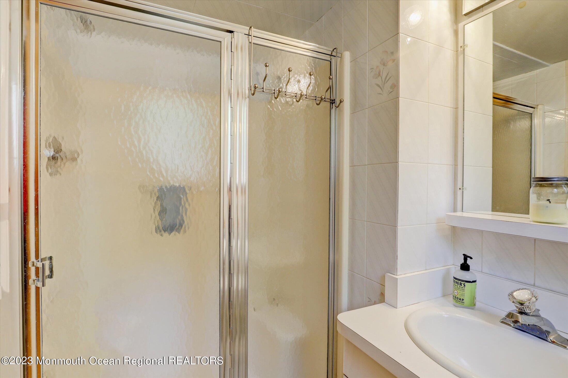5 Ramble Way Hazlet, NJ 07730 - Photo 9 of 34 a bathroom with a shower a sink and a mirror