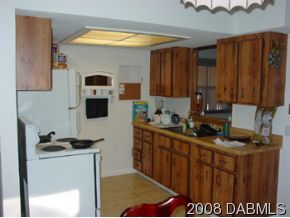 3505 Old Deland Road Daytona Beach, FL 32124 - Photo 4 of 10 a kitchen with stainless steel appliances a stove a sink and a microwave