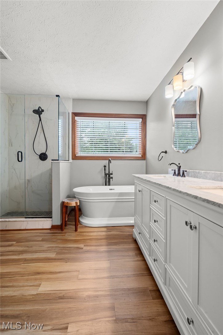5700 Birmingham Road Northeast Canton, OH 44721 - Photo 22 of 37 Owners fully remodeled bathroom with LVT flooring, granite countertops, double vanity, free standing tub, and a walk in closet