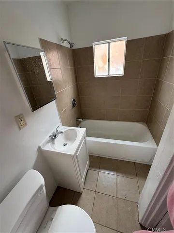 a bath tub sitting in a bathroom next to a window