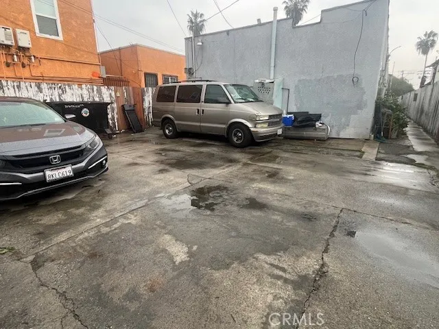 a view of a cars is parked in front of a building