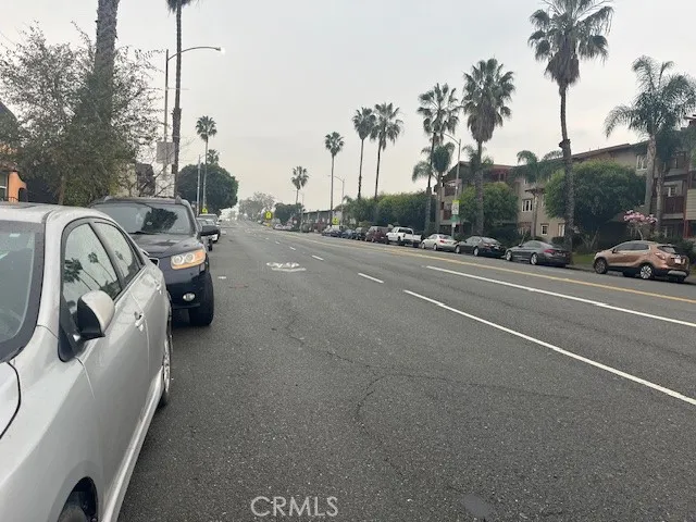 a view of a cars parked on the side of a street