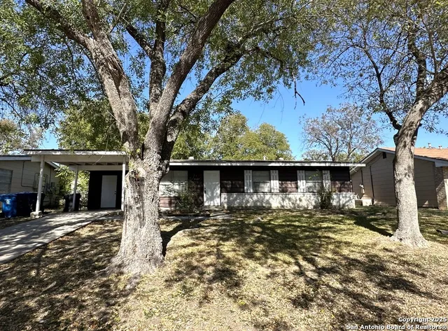 a front view of a house with a yard garage and outdoor seating