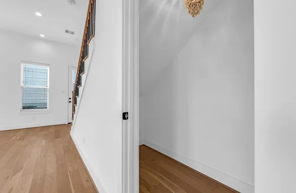 a view of hallway with stairs and wooden floor