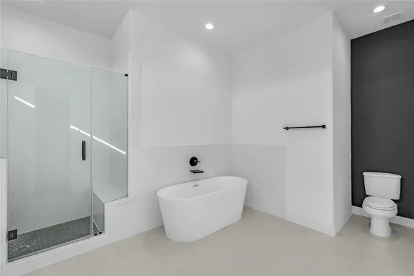 a white bath tub sitting next to a white toilet