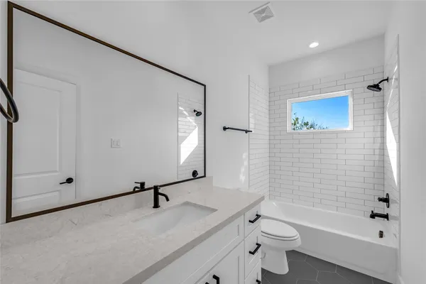 a bathroom with a sink a toilet and a bathtub