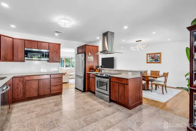 a kitchen with stainless steel appliances granite countertop a stove and a sink