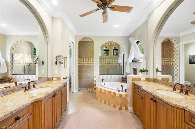 a large spacious bathroom with a granite countertop sink mirror and bathtub