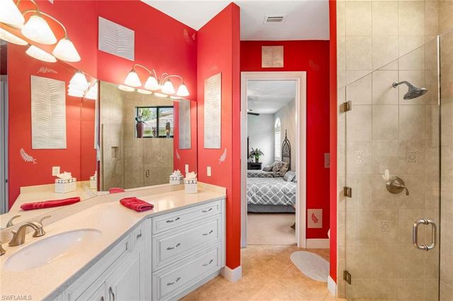 a bedroom with a bed and a mirror