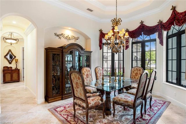 a view of a dining room with furniture and chandelier