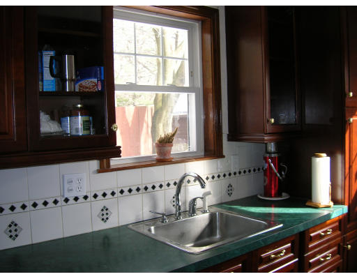 4 Margaret Road Newton, MA 02461 - Photo 7 of 10 a kitchen with granite countertop a stove a sink and a microwave