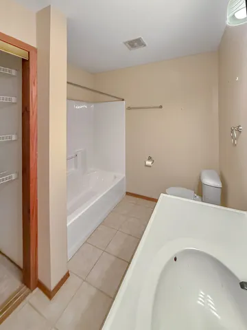 a bathroom with a bathtub and a shower