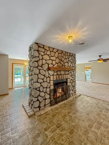 a view of an empty room and fire place