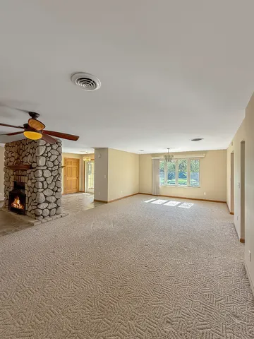 a view of an empty room with a fireplace
