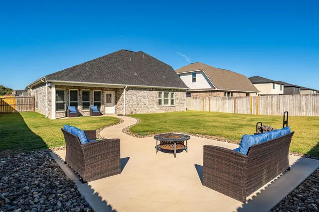 a view of a house with pool and a yard