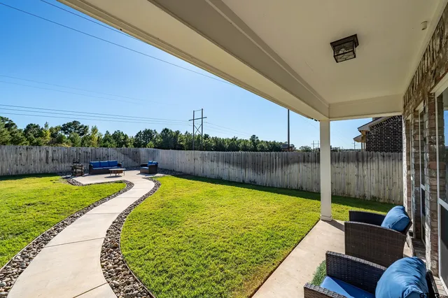 a view of a swimming pool with a couches in a patio