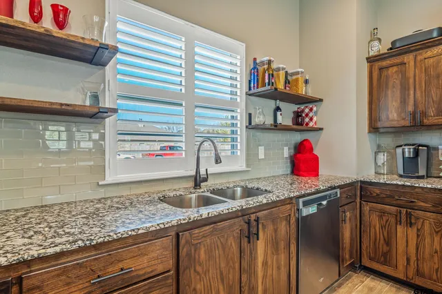 a kitchen with stainless steel appliances granite countertop a sink and cabinets