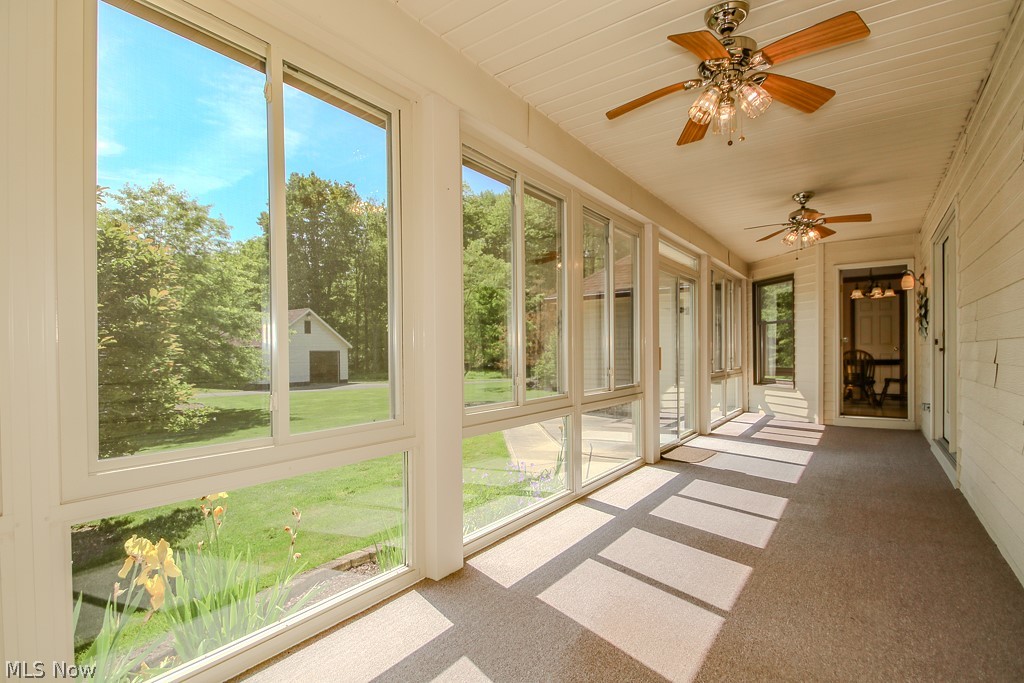 6475 Taylor Road Painesville, OH 44077 - Photo 9 of 23 ceiling windows, multiple ceiling fans with integrated lighting, and neutral carpeting