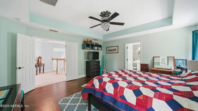 a bathroom with a granite countertop sink toilet and mirror