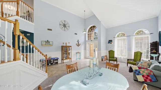 a dining room with furniture and a window