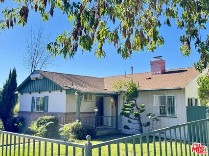 front view of house with potted plants