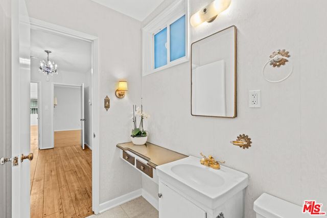a bathroom with a sink mirror and toilet