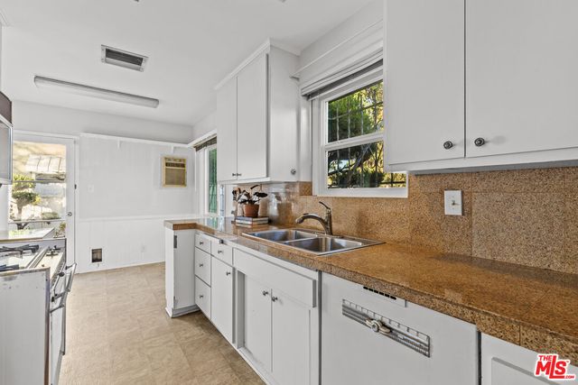 a kitchen with sink cabinets and window