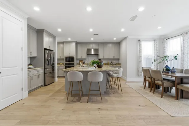 a kitchen with granite countertop a refrigerator and a sink