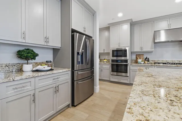 a kitchen with stainless steel appliances granite countertop a sink stove and cabinets
