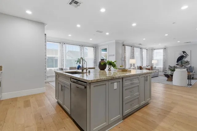 a kitchen with granite countertop white cabinets stainless steel appliances and a sink