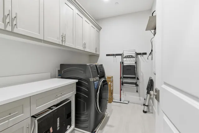 a bathroom with a double vanity sink toilet mirror and shower