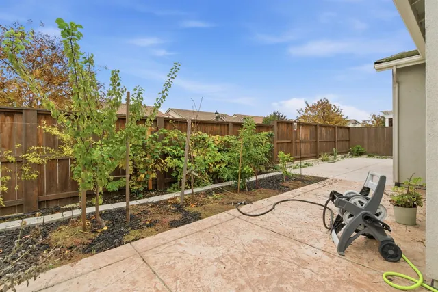 a front view of a house with a yard and potted plants