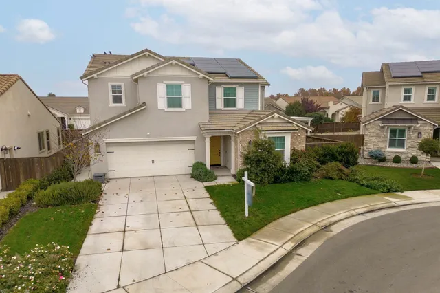 an aerial view of a house with a ocean view