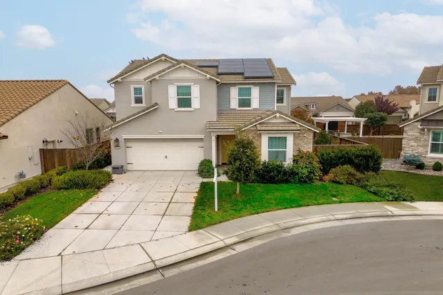 an aerial view of a house with a swimming pool
