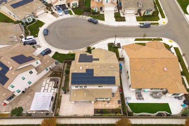 an aerial view of residential houses with outdoor space