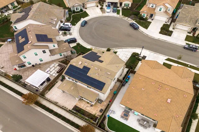an aerial view of residential houses with outdoor space