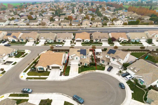 an aerial view of a house with a swimming pool and outdoor seating