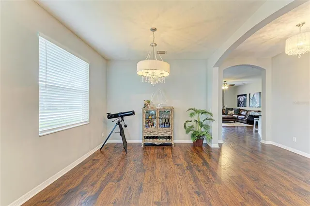 a kitchen with granite countertop a stove a sink and a refrigerator