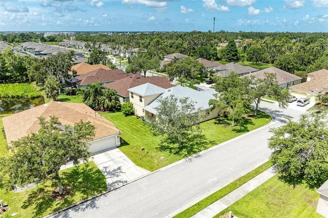 an aerial view of residential houses with outdoor space and street view