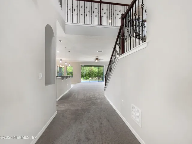 a view of a porch with wooden floor and a window