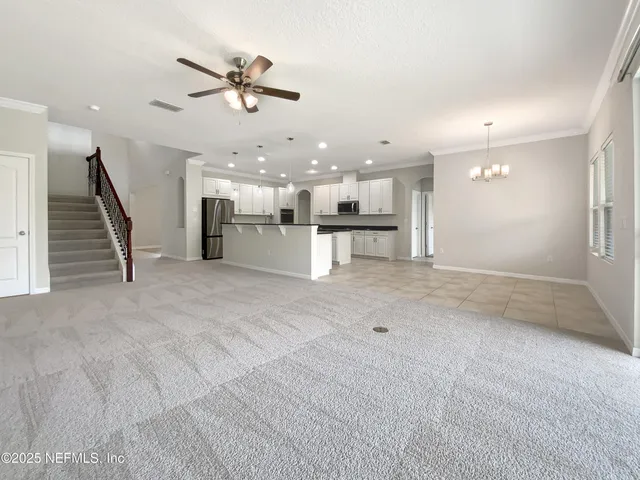 a view of a kitchen with furniture and a ceiling fan
