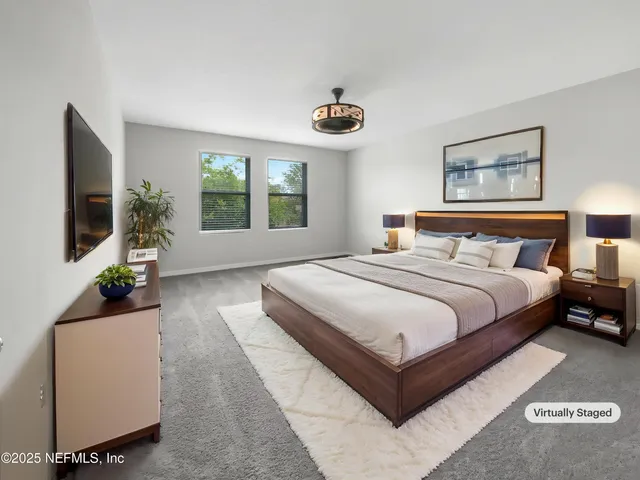 a bedroom with a large bed and a large window