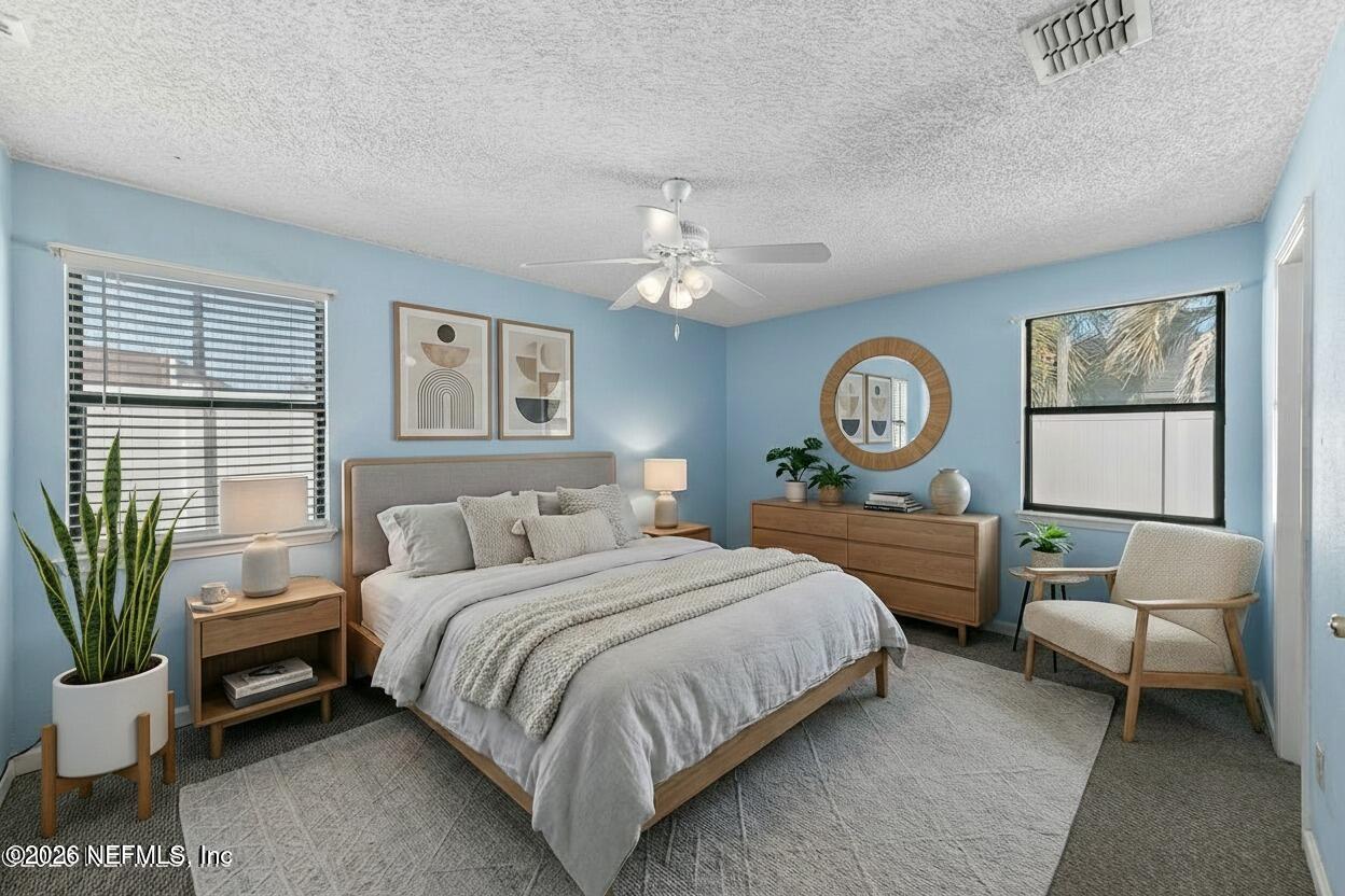 494 Filmore Drive Jacksonville, FL 32225 - Photo 13 of 25 a bedroom with a bed and a chandelier