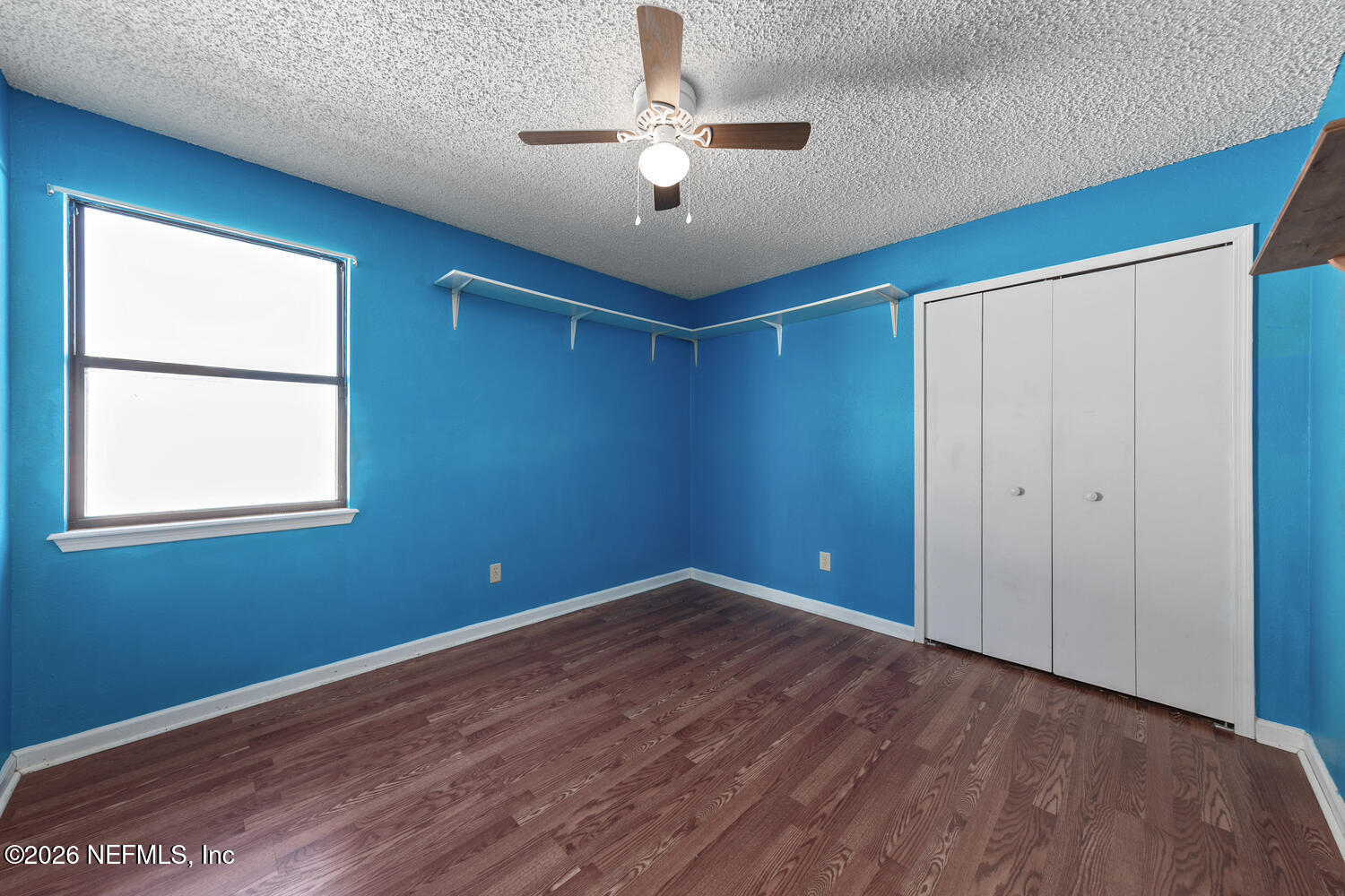 494 Filmore Drive Jacksonville, FL 32225 - Photo 17 of 25 a view of empty room with wooden floor and fan